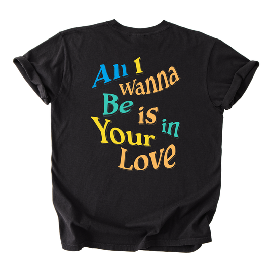 Black t-shirt with colorful text 'All I wanna Be is in Your Love' on a white background